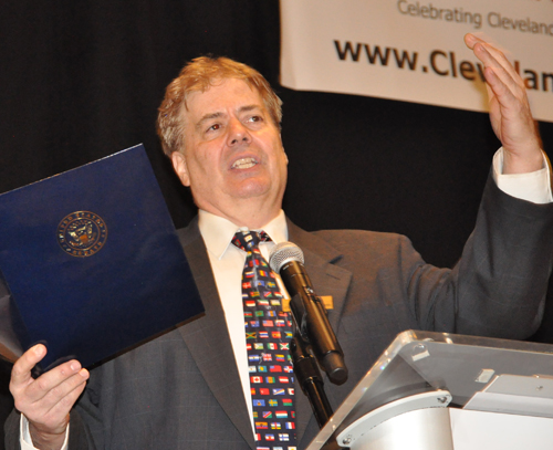 Dan Hanson displaying proclamations for the inductees